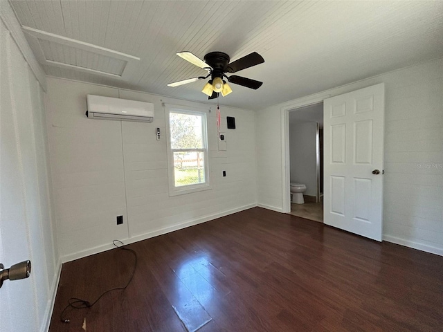 spare room with dark hardwood / wood-style floors, a wall mounted AC, and ceiling fan