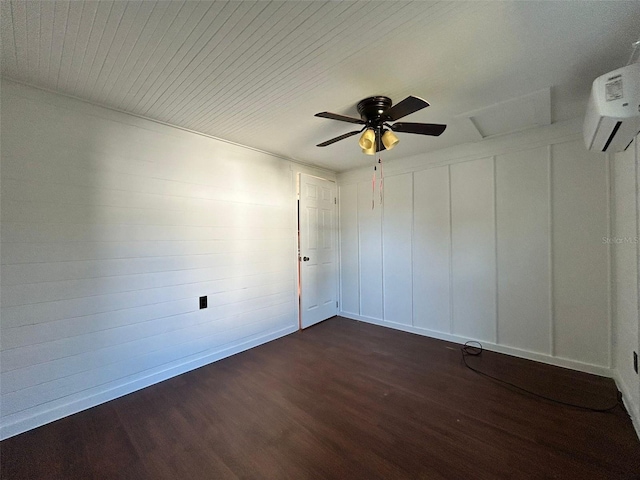 empty room featuring ceiling fan, dark wood-type flooring, and a wall unit AC