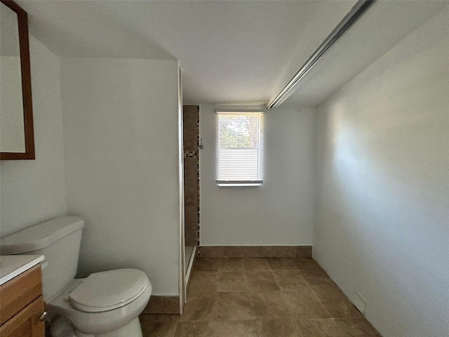 bathroom with vanity, toilet, and walk in shower