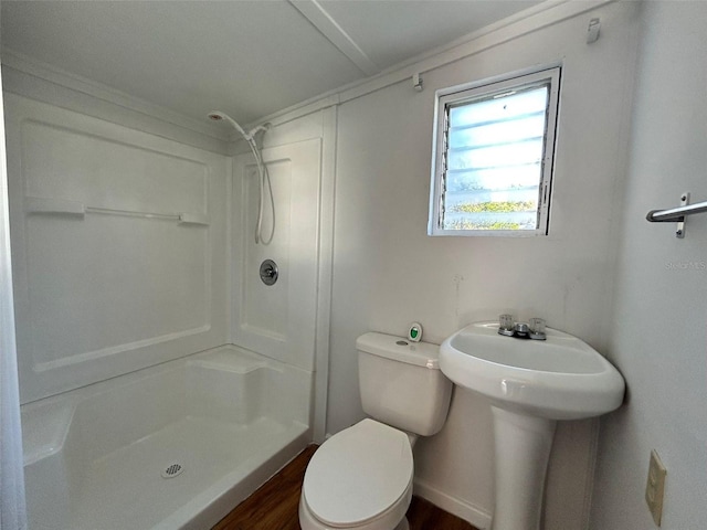 bathroom featuring hardwood / wood-style floors, toilet, and walk in shower