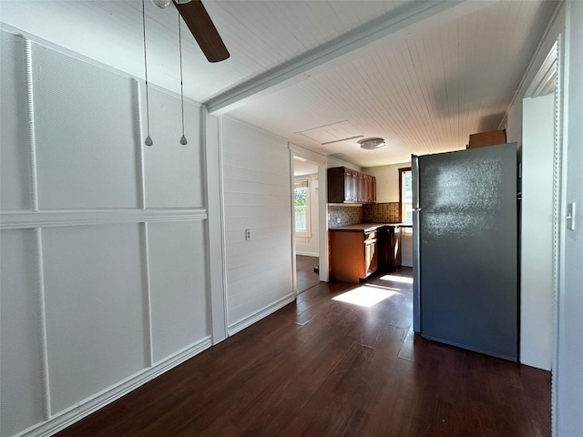 kitchen with dark hardwood / wood-style flooring, ceiling fan, and black refrigerator