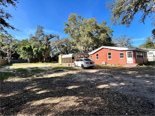 view of yard with a carport and central air condition unit