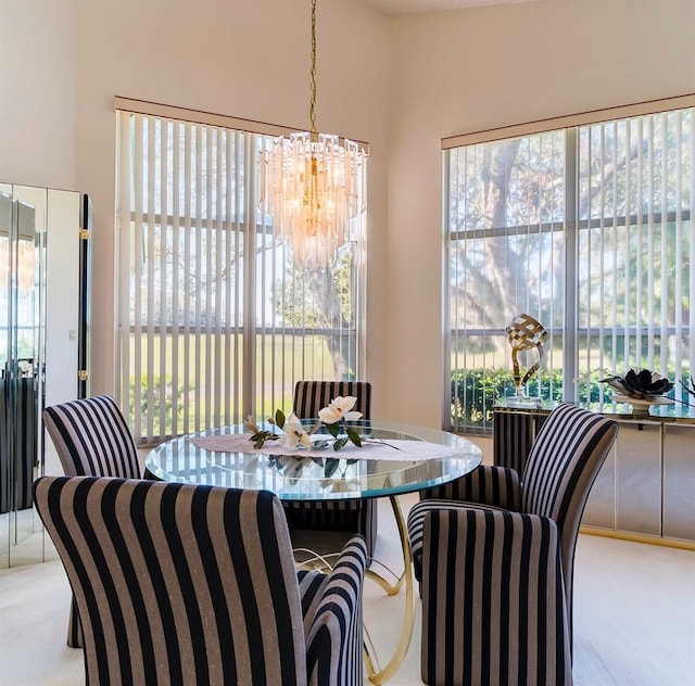 dining area featuring a wealth of natural light, carpet floors, and a chandelier