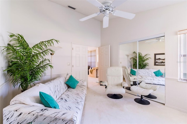 living area with carpet flooring and ceiling fan