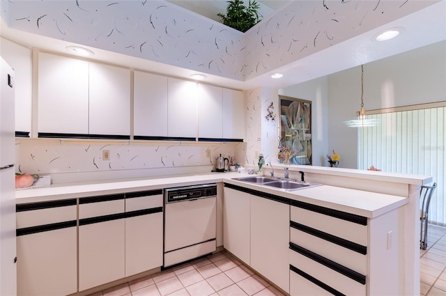 kitchen with white cabinetry, dishwasher, and hanging light fixtures