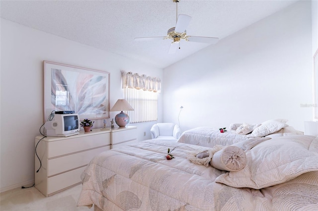 bedroom with a textured ceiling, ceiling fan, light colored carpet, and lofted ceiling