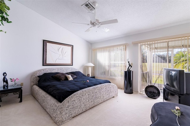 bedroom with a textured ceiling, ceiling fan, lofted ceiling, and carpet floors