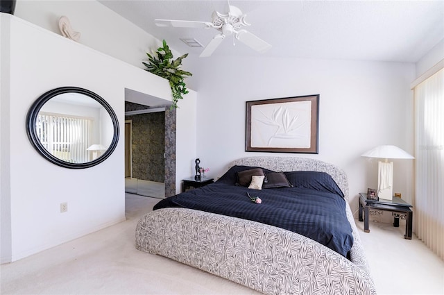 carpeted bedroom with ceiling fan and vaulted ceiling