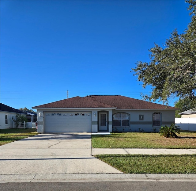 single story home featuring a front lawn and a garage