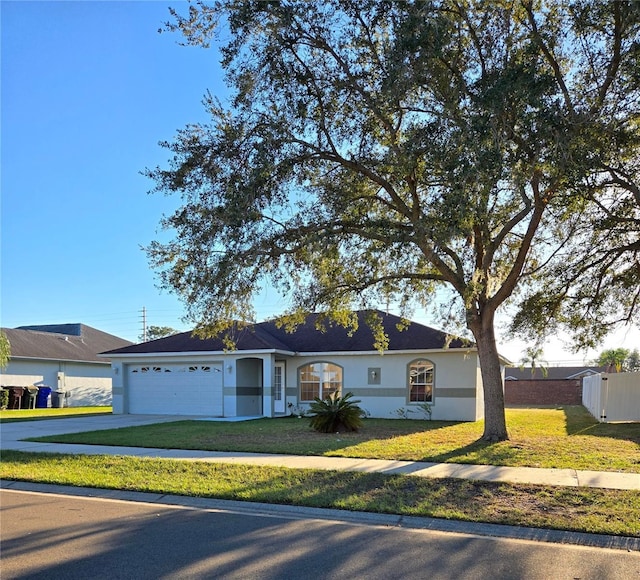 ranch-style house with a garage and a front yard