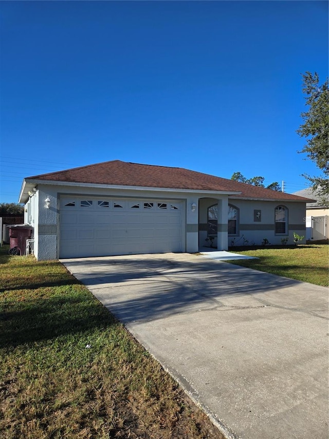 single story home with a front lawn and a garage