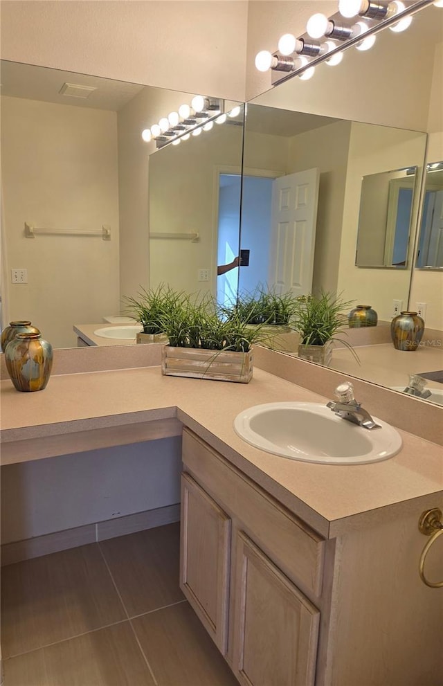 bathroom with tile patterned flooring and vanity