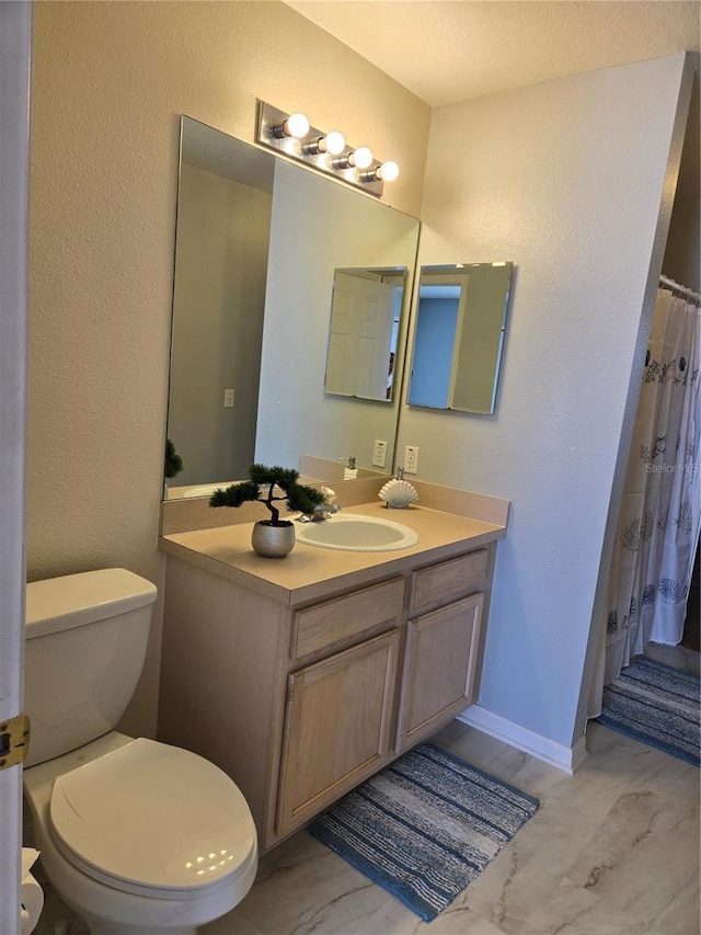 bathroom featuring vanity and toilet