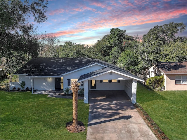 view of front facade with a yard and a carport