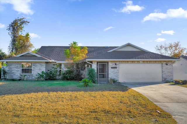 ranch-style house featuring a garage and a front lawn