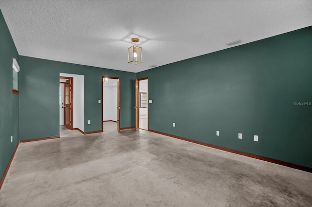 unfurnished room featuring a textured ceiling