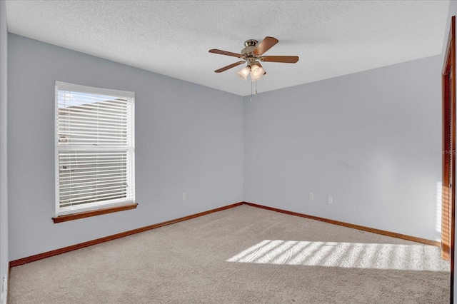 unfurnished room featuring carpet, a textured ceiling, and ceiling fan