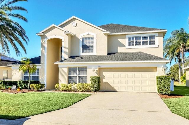 view of front of property with a front yard and a garage