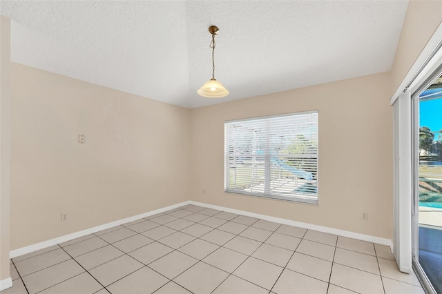 unfurnished dining area featuring light tile patterned floors and a textured ceiling