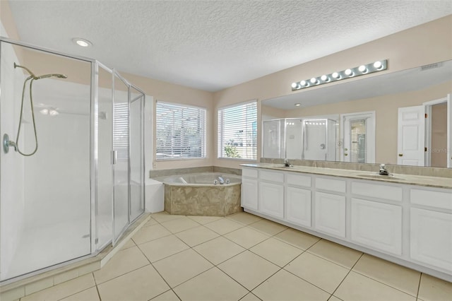 bathroom featuring tile patterned flooring, vanity, a textured ceiling, and shower with separate bathtub