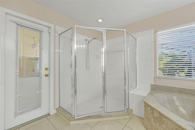 bathroom with tile patterned flooring, a textured ceiling, and independent shower and bath