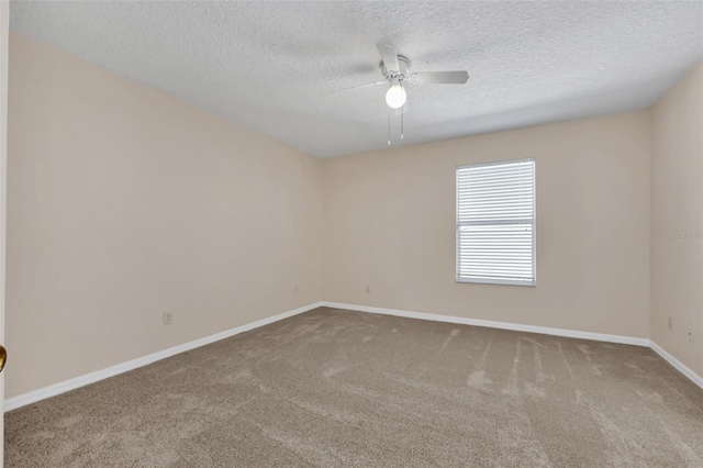 carpeted spare room featuring a textured ceiling and ceiling fan