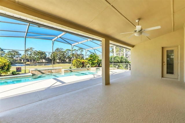 view of pool with glass enclosure, ceiling fan, and a patio area