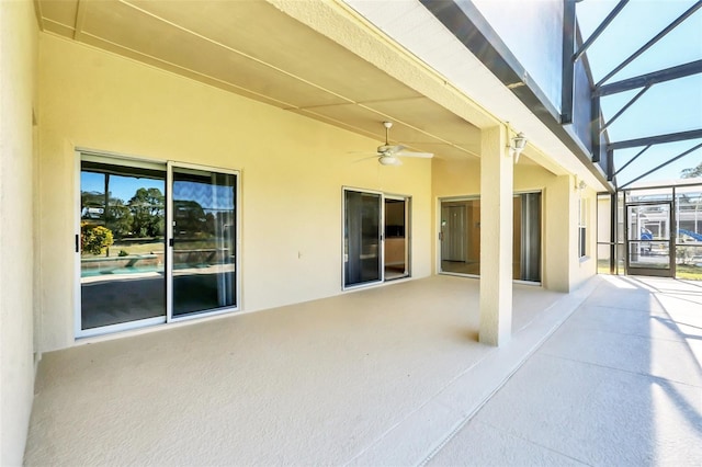 view of patio featuring ceiling fan and a lanai