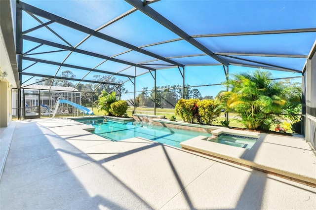 view of pool with a patio, a lanai, an in ground hot tub, and a water slide