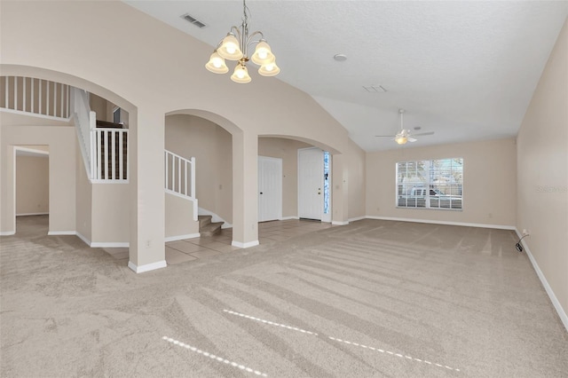 spare room with ceiling fan with notable chandelier, light colored carpet, and lofted ceiling