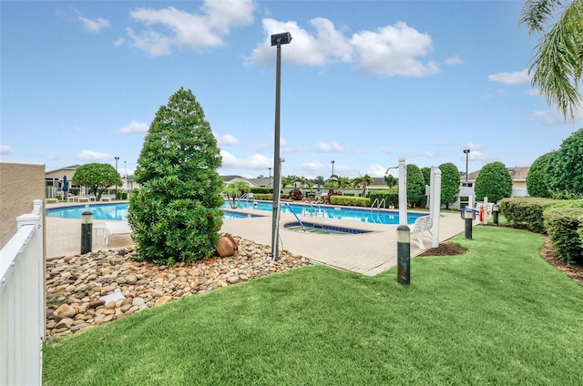 view of swimming pool with a lawn