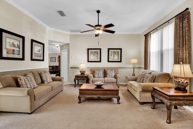 living room with crown molding, ceiling fan, and light colored carpet