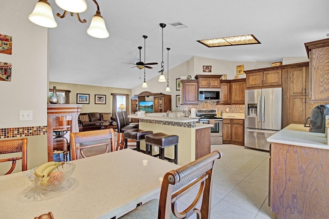 dining area featuring ceiling fan, light tile patterned floors, and lofted ceiling