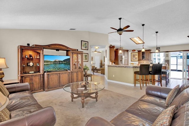 tiled living room featuring a textured ceiling, ceiling fan, and lofted ceiling