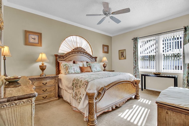 bedroom featuring ceiling fan, light colored carpet, ornamental molding, and a textured ceiling