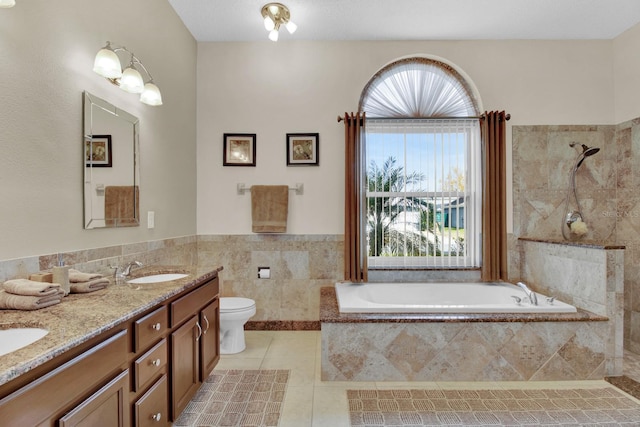 full bathroom featuring tile patterned flooring, vanity, shower with separate bathtub, and toilet