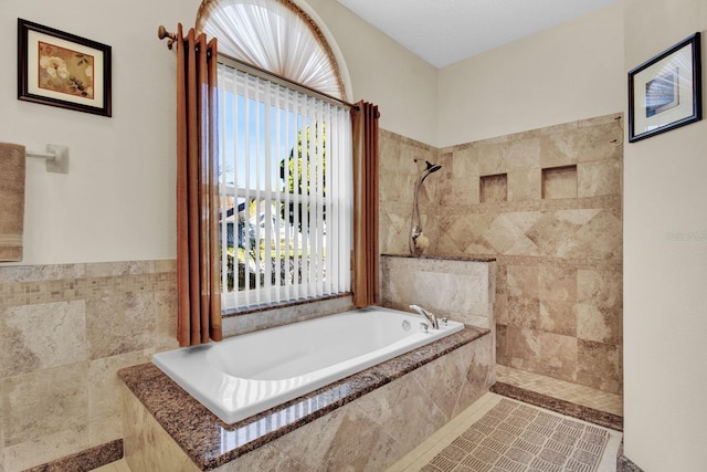 bathroom with plus walk in shower and a wealth of natural light