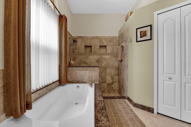 bathroom with tile patterned flooring and separate shower and tub