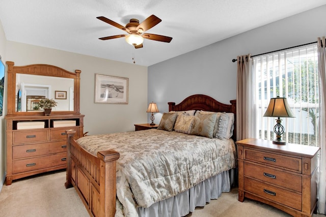 carpeted bedroom with multiple windows, ceiling fan, and a textured ceiling