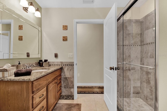 bathroom with vanity, tile patterned floors, and walk in shower