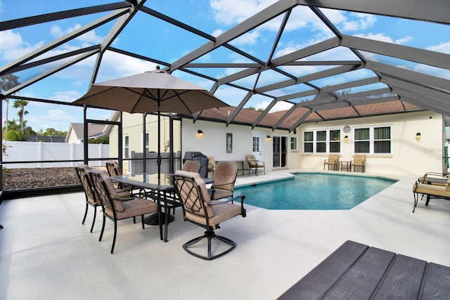 view of pool with a patio and glass enclosure