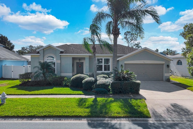 ranch-style home with a garage and a front lawn