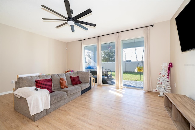 living room featuring light hardwood / wood-style floors and ceiling fan