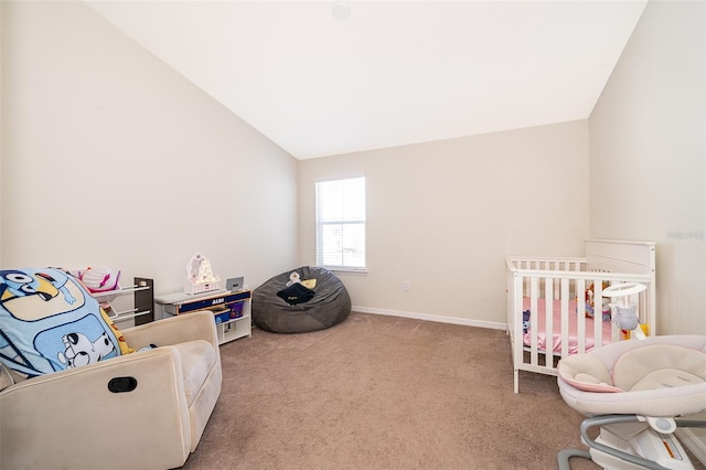 carpeted bedroom with a crib and lofted ceiling