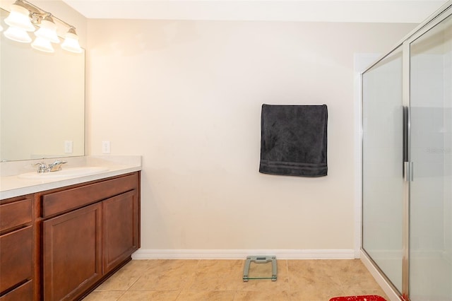 bathroom featuring tile patterned floors, vanity, and walk in shower