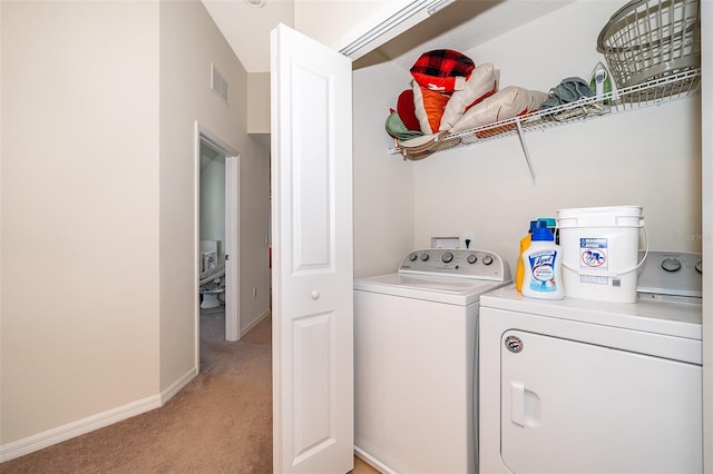 washroom with light carpet and washer and dryer