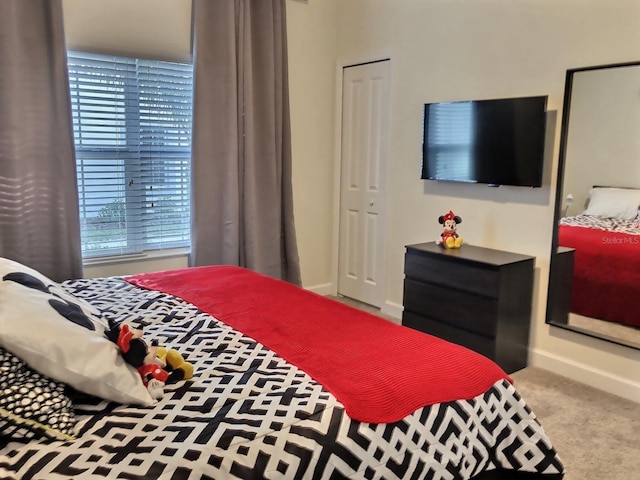 carpeted bedroom with a closet