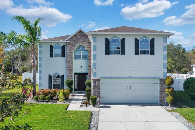 view of front of property with a garage and a front lawn