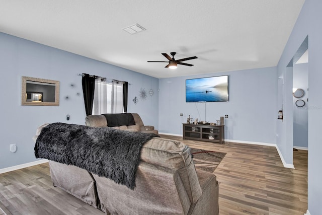 living room with hardwood / wood-style flooring and ceiling fan