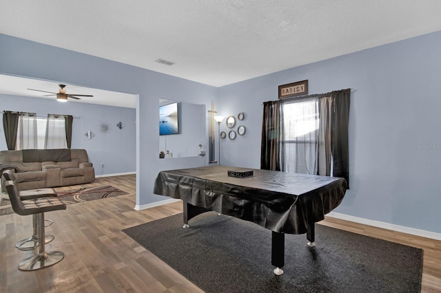 playroom with hardwood / wood-style flooring, ceiling fan, a textured ceiling, and billiards